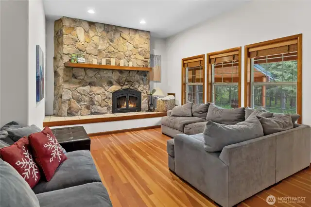 Cozy living room with wood burning fireplace.