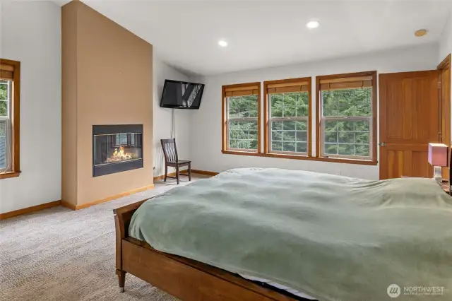 Bright and open primary suite with gas fireplace.