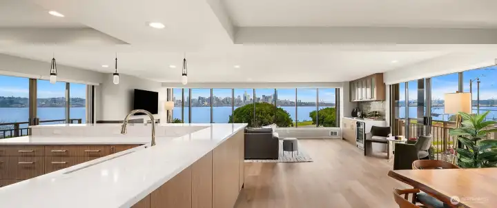 Panoramic view of the living room, dining room and kitchen with the views on 3 sides