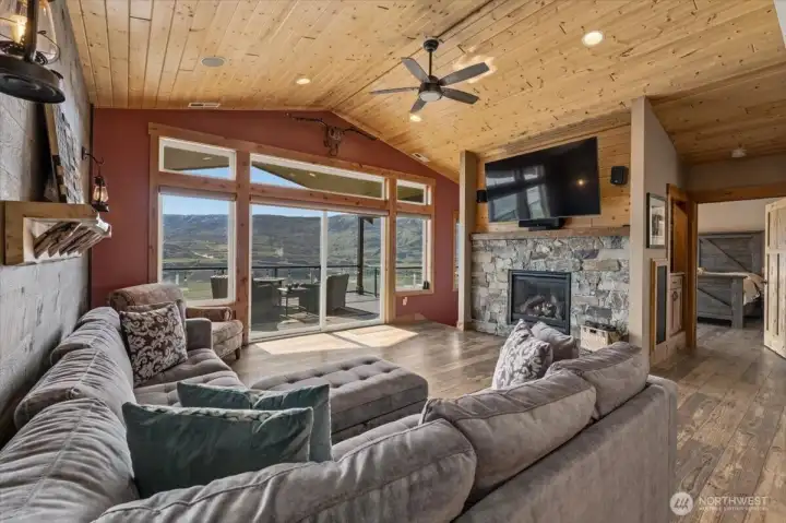 Great room features a stone surround Heat & Glo fireplace, vaulted pine ceilings, surround sound and Milgard windows and double glass sliding doors leading out to the spacious deck overlooking the Columbia River.