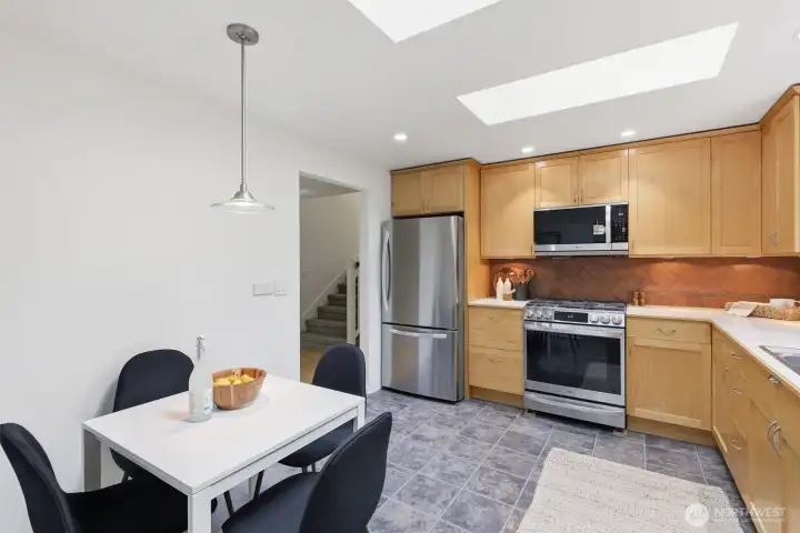 Functional and well-appointed, the kitchen offers a sunny eating nook.