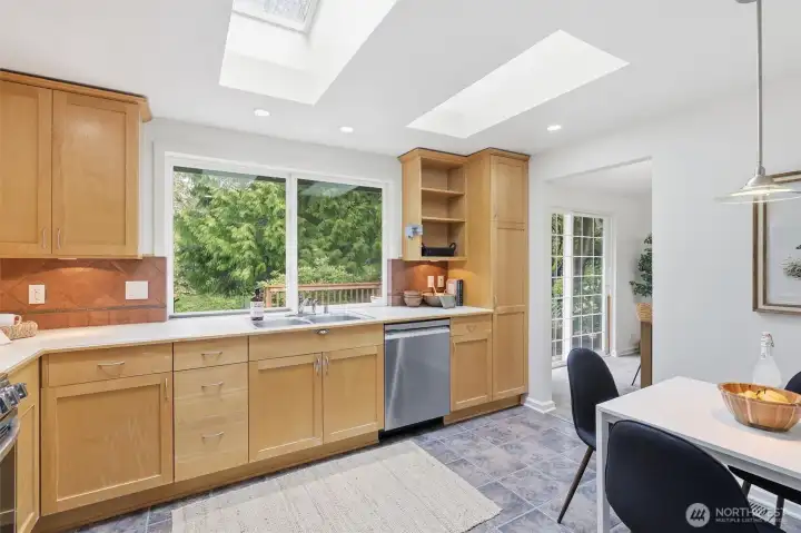 Two skylights and the large vinyl window overlooking the deck drench the kitchen in natural light.