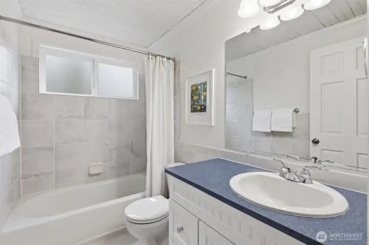 This well-appointed bathroom supports the upstairs bedrooms.