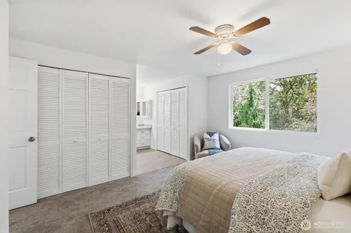Closets flank the primary; a ceiling fan keeps the room cool in the Summers.