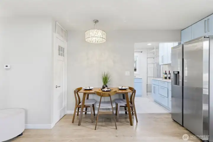 Dining area, with furnace through door on left of table.