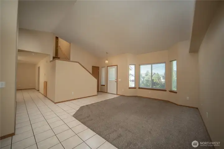 Bright open floor plan with vaulted ceilings throughout the living room