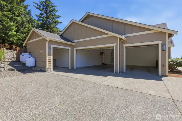 JUST SHY OF 1000 SF OF GARAGE SPACE, THREE CAR GARAGE HAS A 240V OUTLET/EV-CHARGER. SINGLE GARAGE IS PERFECT FOR EXTRAS.