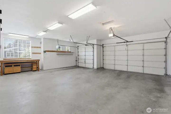 LUXURY THREE CAR GARAGE HAS ROOM FOR CARS, TOYS, AND TOOLS.