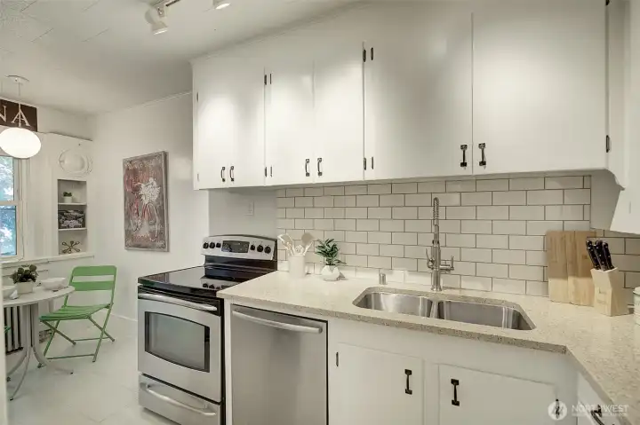 Kitchen is updated with quartz countertops and stainless steel appliances. Kitchen is updated with quartz countertops and stainless steel appliances.
