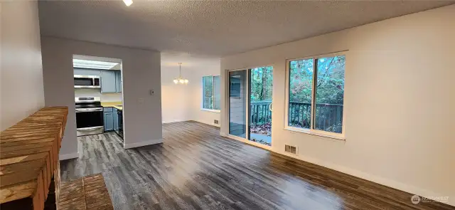 Living Room looking into the Kitchen & Dining Area. Note the greenbelt in the background.