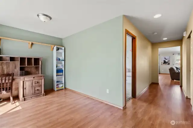 Front entrance view with flex space and first bedroom on the left and a large closet on the right.