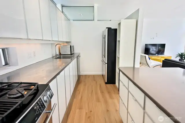 Propane range/oven, stainless appliances, and plenty of storage/cabinets....