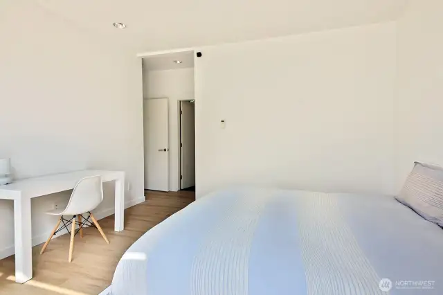 Primary bedroom. Door to the left is to the hallway and to the right is to the bathroom.