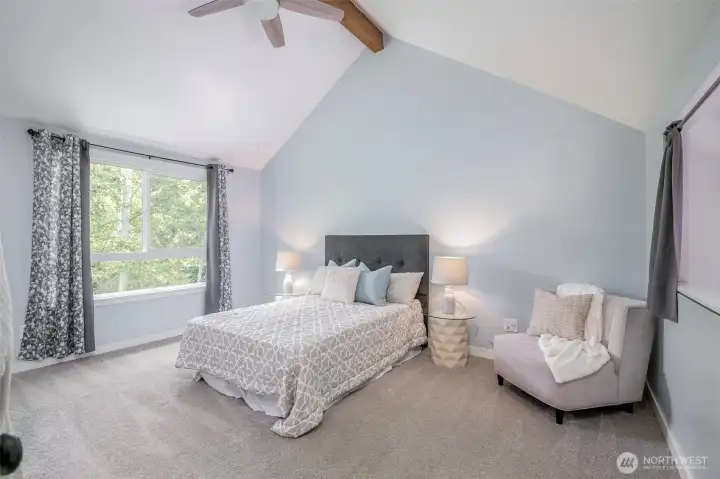 Spacious primary suite overlooking the private backyard