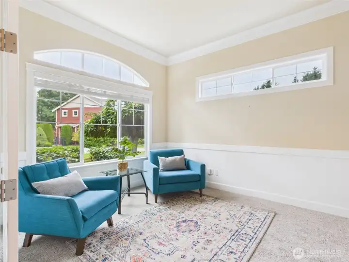 Den with picture window and French doors.