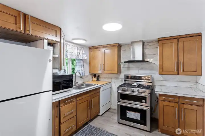 Newer gas double oven/range.  All appliances stay.