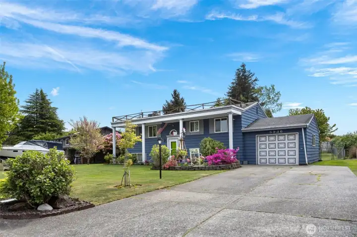 Single car garage with driveway parking to fit multiple cars and room for a trailer/RV.