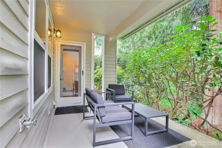 Enjoy the summer days on the shaded rear patio that is adjacent to the green space.