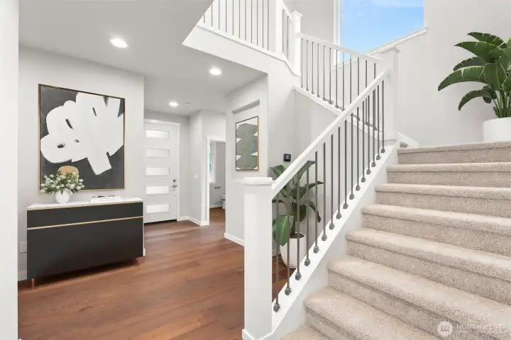 Foyer with open railing system with metal railings.