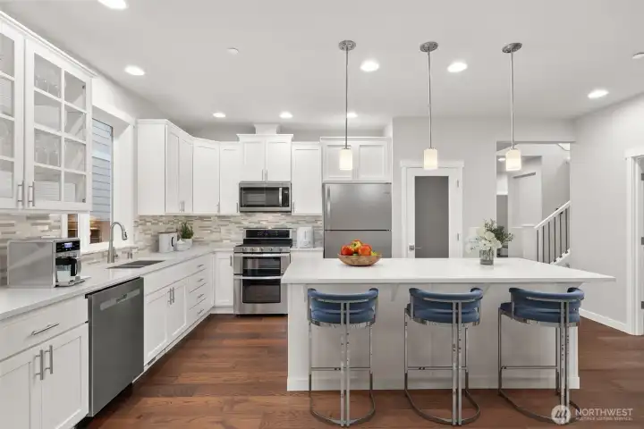 Functional kitchen with hardwood floors and KitchenAid appliances featuring 36 in R/O.