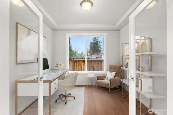 Main floor den/ flex space with French doors and hardwood floors.