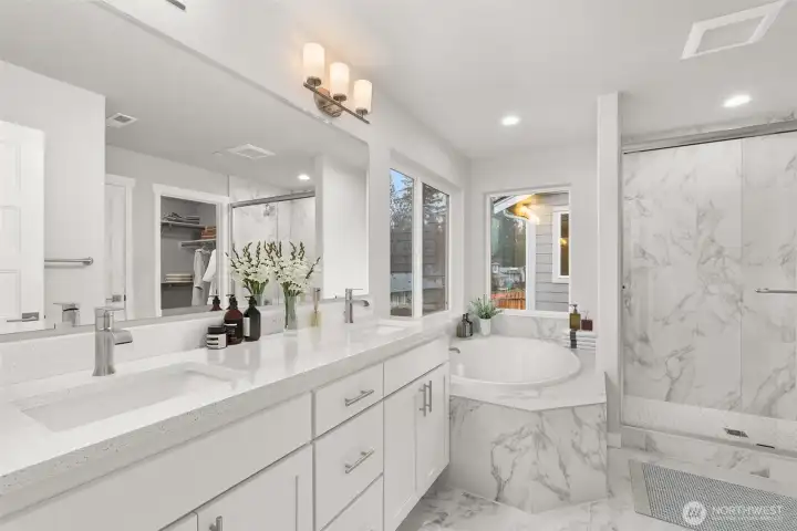 Luxurious 5 -Piece Primary Bath En-suite with quartz counters and glass enclosed shower.