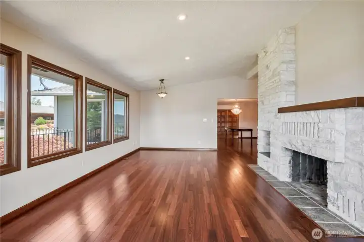Family Room with views of the Columbia River, stunning marble  fireplace and custom built in shelf.