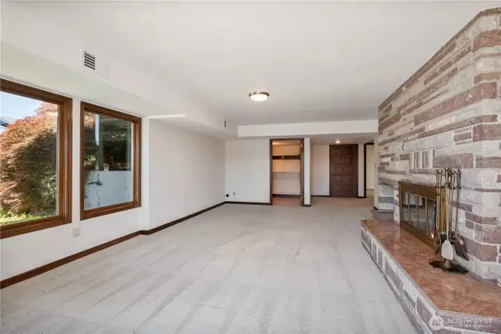 Bonus living space on the lower level with wood burning fireplace and access to the beautiful grounds with river views.