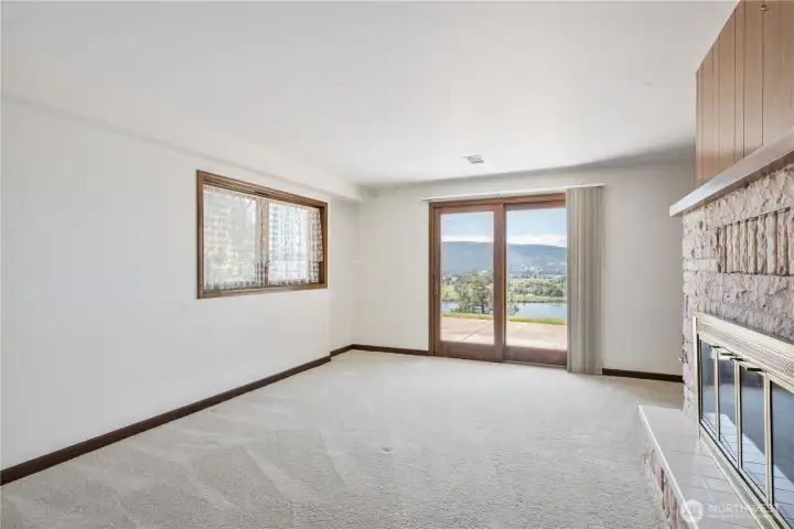 Second primary suite on the lower level with slider to the beautiful grounds and river views.