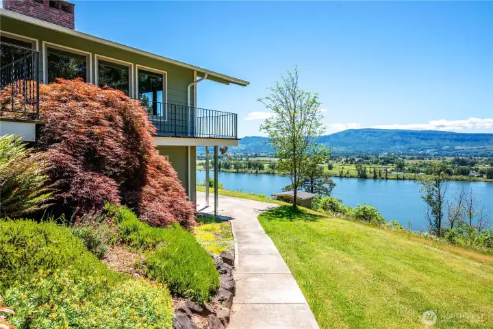 Professionally landscaped with paved walkways, patios and decks that all lead to stunning river views.