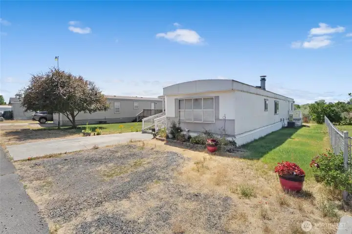 Lots of parking! Plenty of grass on the sides of the home, and the fencing will keep your little pets close by. Lots of parking! Plenty of grass on the sides of the home, and the fencing will keep your little pets close by.