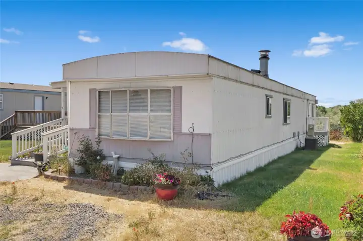 The front of the home has many flowers blooming in the spring and summer. The dining room is at the front of the home. The front of the home has many flowers blooming in the spring and summer. The dining room is at the front of the home.