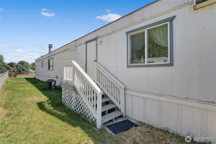 Side door and porch on the side. Kinda handy for letting pets out in a smaller, dedicated area for them. Side door and porch on the side. Kinda handy for letting pets out in a smaller, dedicated area for them.