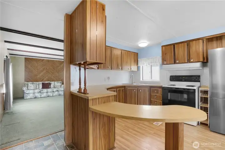 It's amazing how large a kitchen and dining room can be in a singlewide, but they built this one well to fit several people in the space! It's amazing how large a kitchen and dining room can be in a singlewide, but they built this one well to fit several people in the space!