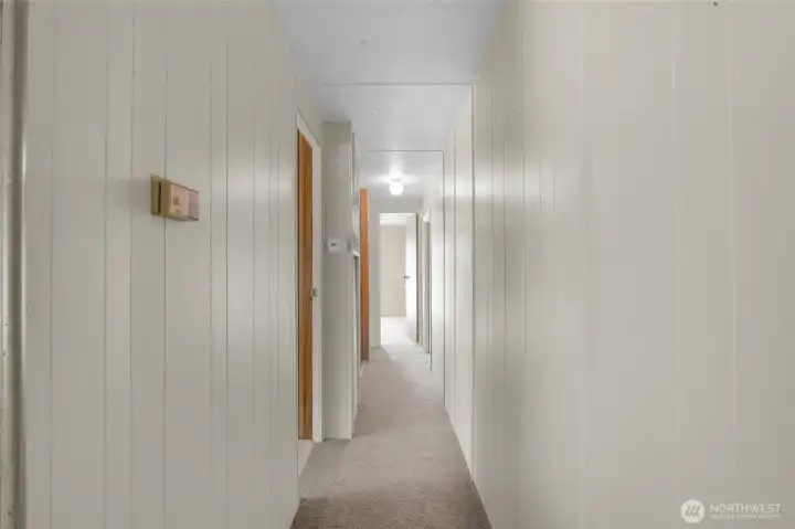 Hallway down to the bedrooms, one on the left and one at the end of the hallway by the bathroom. Hallway down to the bedrooms, one on the left and one at the end of the hallway by the bathroom.