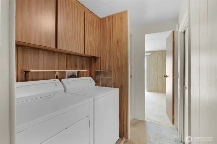 Laundry area with cupboard space. The washer and dryer stay with the home. Laundry area with cupboard space. The washer and dryer stay with the home.