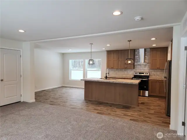 Another view of the beautiful cabinetry and dining area.  The island has plenty of room for 3 stools for more eating space while dining.