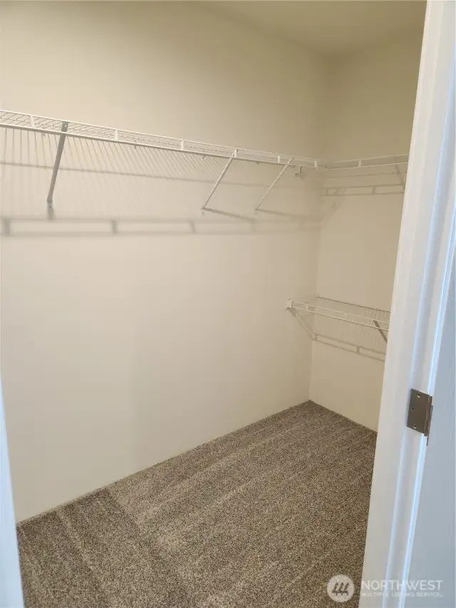 One side of the walk-in closet in primary bedroom.