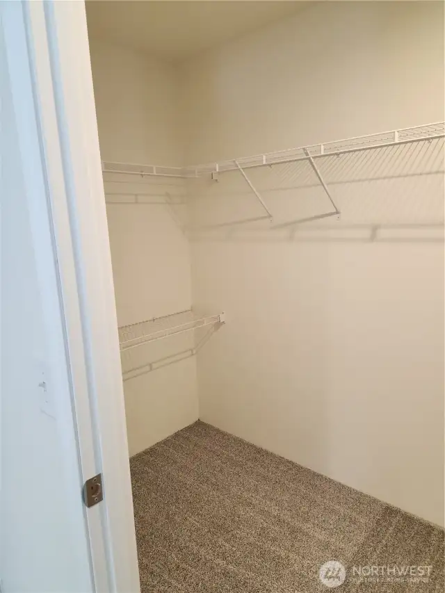 Other side of the spacious walk-in primary closet.