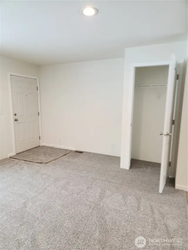 View of front entry door on left and coat closet at entry.