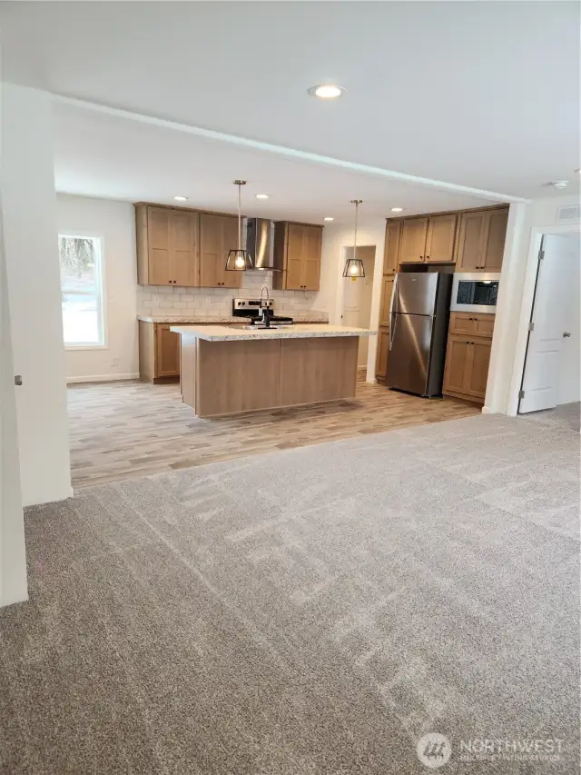 View of open concept kitchen to the livingroom area. Easy entertaining with guests while cooking a meal in the well laid out kithcen.