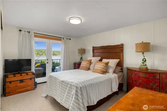 The primary bedroom has gracious French doors leading onto the deck.