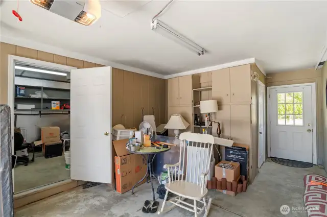 back of garage with built in storage and access to the large backyard.