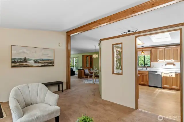 Living room looking into kitchen and dining room.  Small glimpse of family room