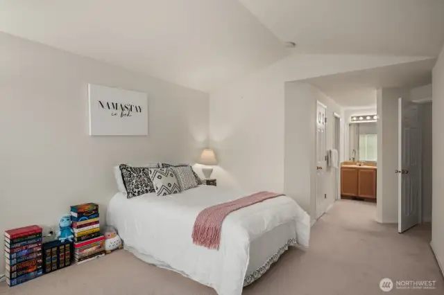 Primary Bedroom with vaulted ceiling, walk-in closet, bath