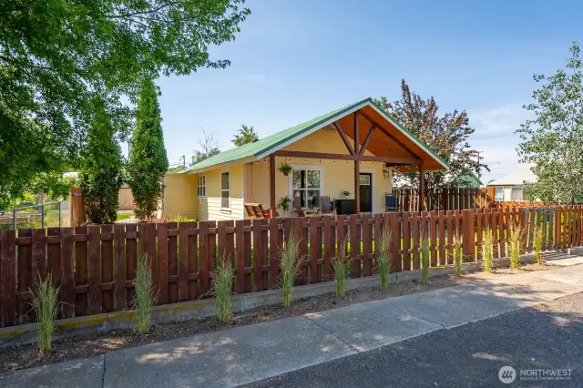 A fully fenced yard defines the space.