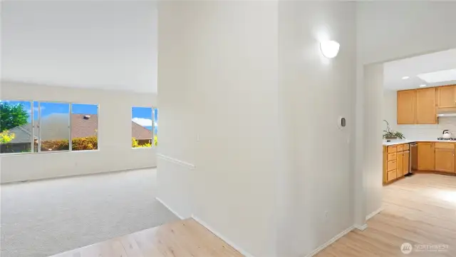 Hardwood floors in the entry, hallway, kitchen, pantry, and the dining room.  Kitchen is to the right and bedrooms to the left.