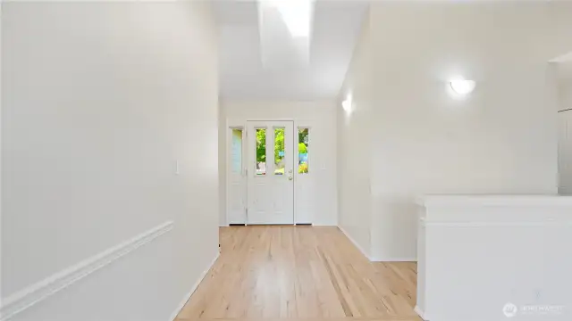 From the living room looking back at the entry.  Note the skylights bring in the wonderful sunshine.