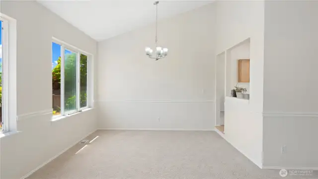 See that the living room flows into the dining room and kitchen areas.  High ceiling makes the sunshine fill this room.