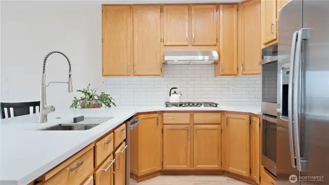 You are going to love this kitchen! It's been totally remodeled, with all new appliances. It's just been outfitted with a double oven, refrigerator, dishwasher, gas stove, and range hood. There is also a new sink and faucet. And to top it all off, the whole kitchen has a large new countertop. Plus, there is a walk-in pantry right by the refrigerator!
